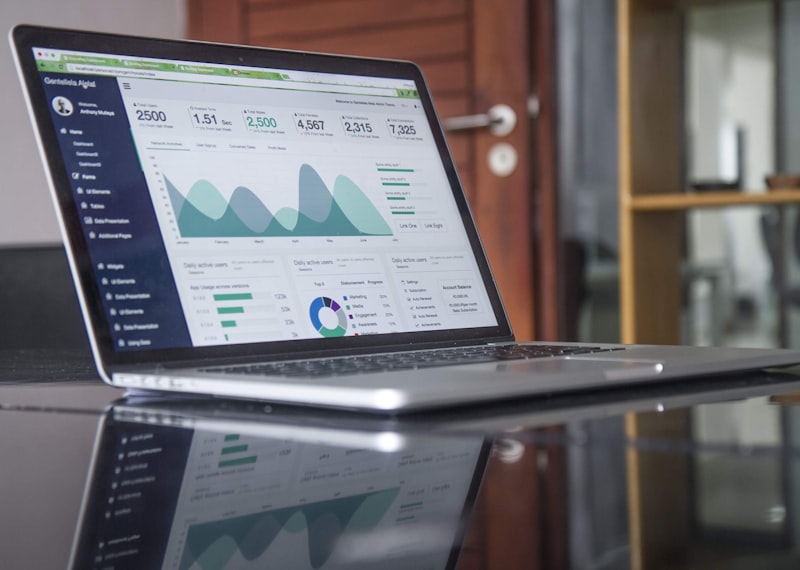 A laptop displaying growth analytics and charts