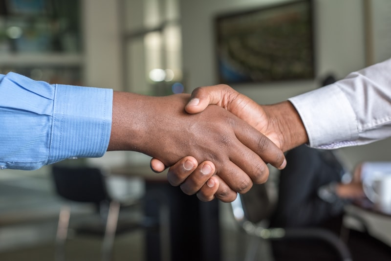 A handshake representing the blending of two approaches