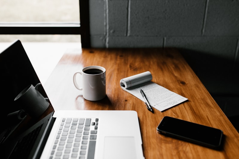 A laptop and coffee representing a consistent working routine