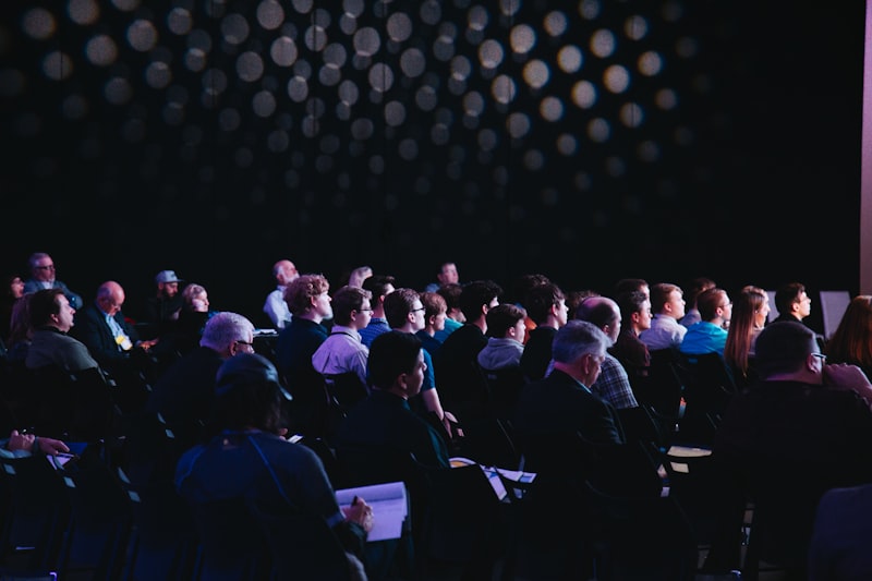 A speaker presenting on stage representing the finals presentation